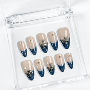 Blue nails with flowers, nude base and glitter French tips.