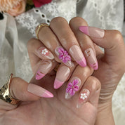 acrylic pink almond nails medium almond press-on nails with nude base pink ombre french tips and small flower accents for prom spring beach party style