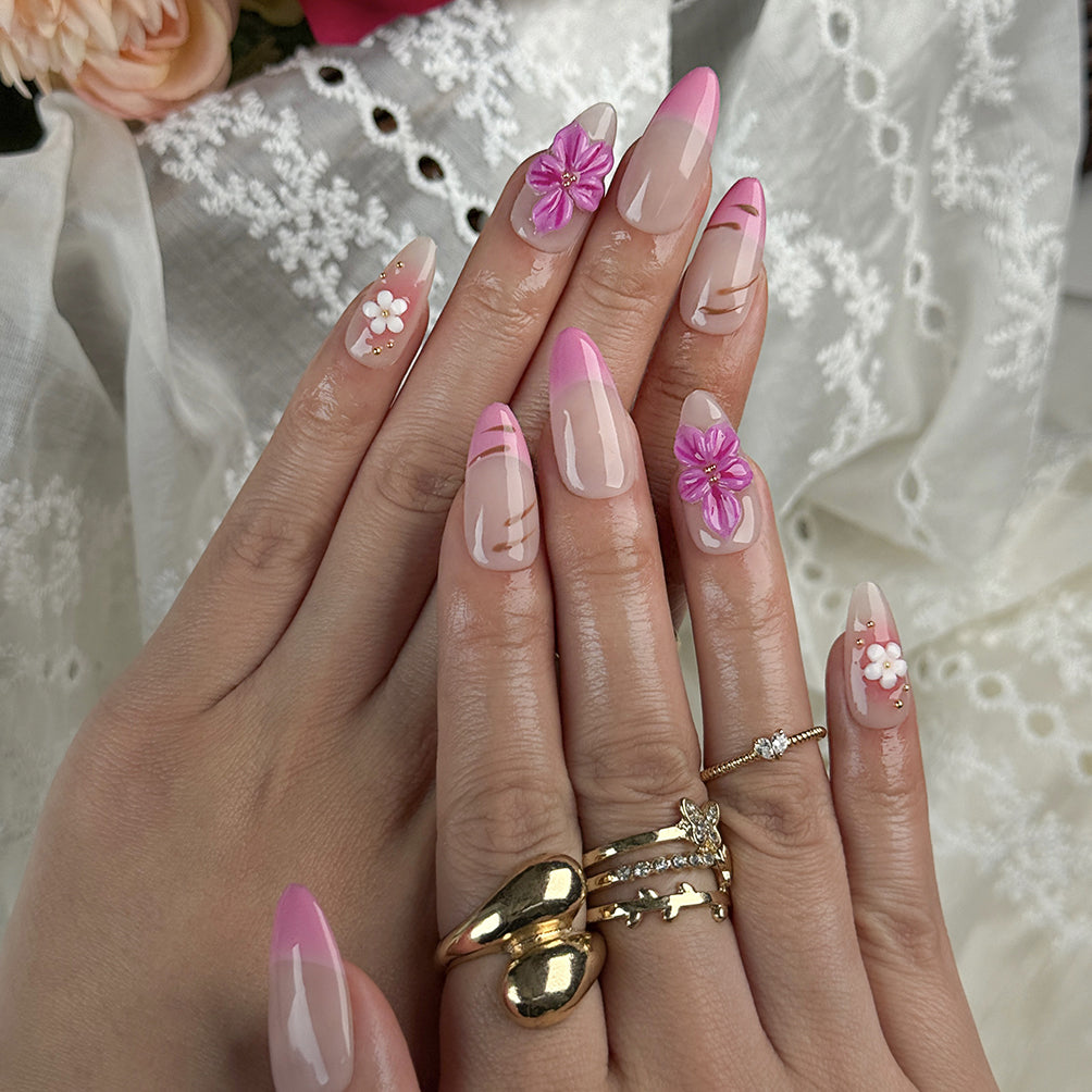 acrylic pink almond nails medium almond press-on nails with nude base pink ombre french tips and small flower accents for prom spring beach party style