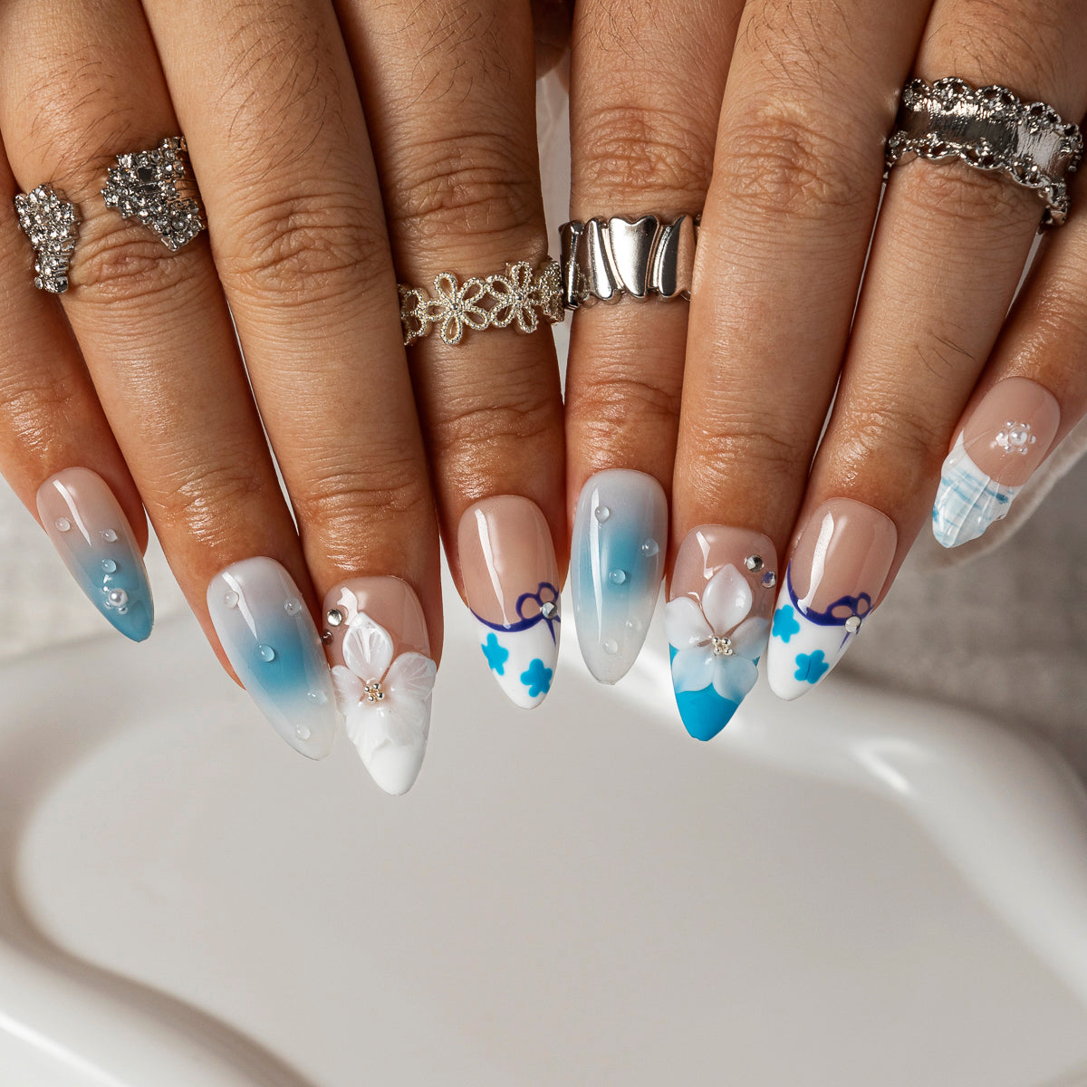 Blue Lace Bloom ALME0083 press-on nails hand model scene view 2