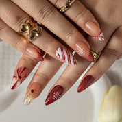 Burgundy Ribbon Snow ALME0108 press-on nails hand model scene view 3
