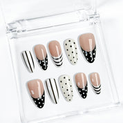 black and white striped nails medium almond press-on set with black French tips and polka dot accents
