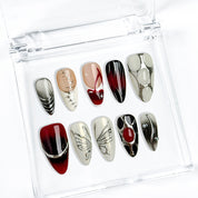 black silver glitter nails medium almond press-on nails in black and white with metallic silver luster winter holiday cool style