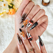 black silver nail art long stiletto press-on nails with black orange flower accents for fall winter holiday