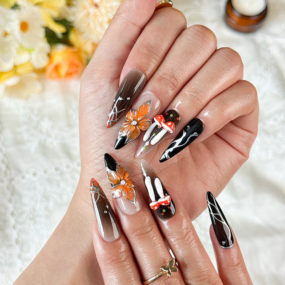 black silver nail art long stiletto press-on nails with black orange flower accents for fall winter holiday