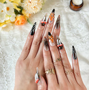 black silver nail art long stiletto press-on nails with black orange flower accents for fall winter holiday