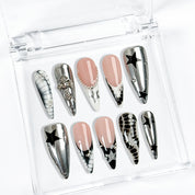 black silver nail art long stiletto press-on nails with metallic luster and black star details for winter holiday