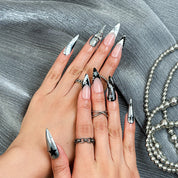 black silver nail art long stiletto press-on nails with metallic luster and black star details for winter holiday