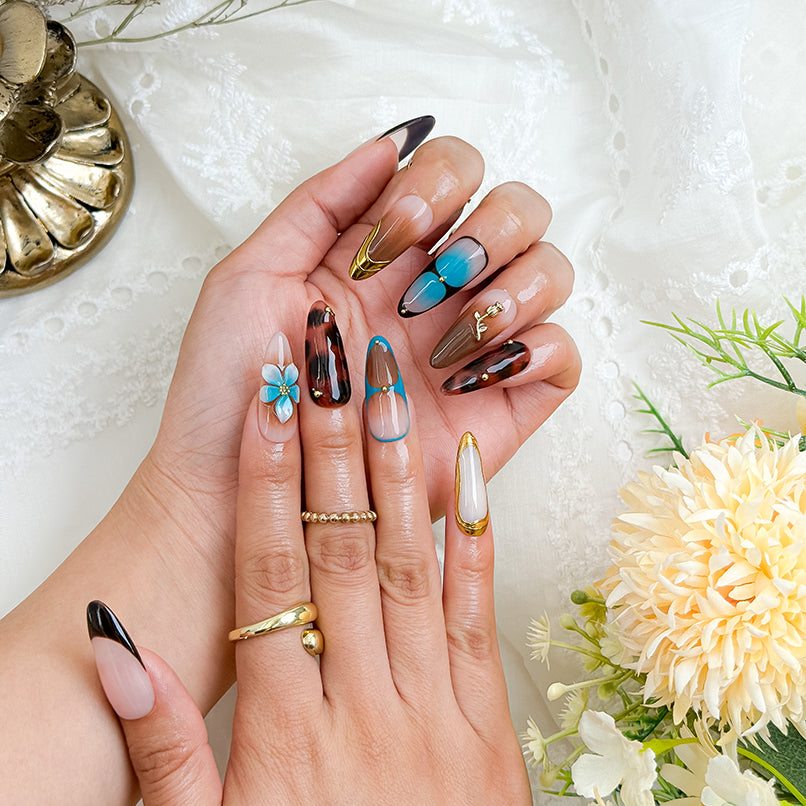 black with gold nails long almond press-on nails with blue brown flower and metallic gold details
