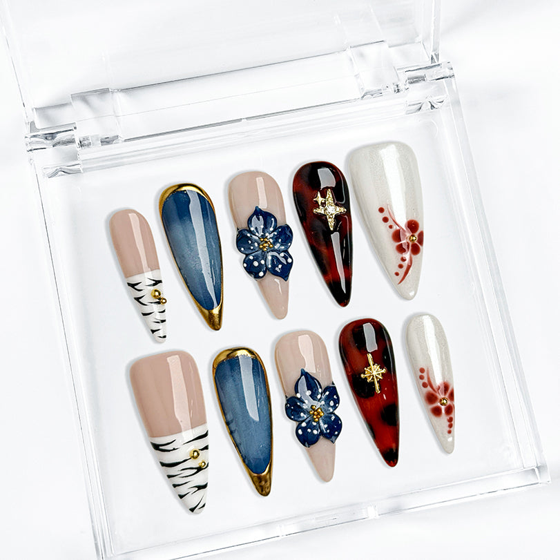 blue almond nails long stiletto press-on nails with blue gold and white accents flower detail winter holiday cool style