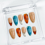 blue and orange nails medium almond press-on nails with nude base blue accents warm amber tips and simple nail art fall holiday style