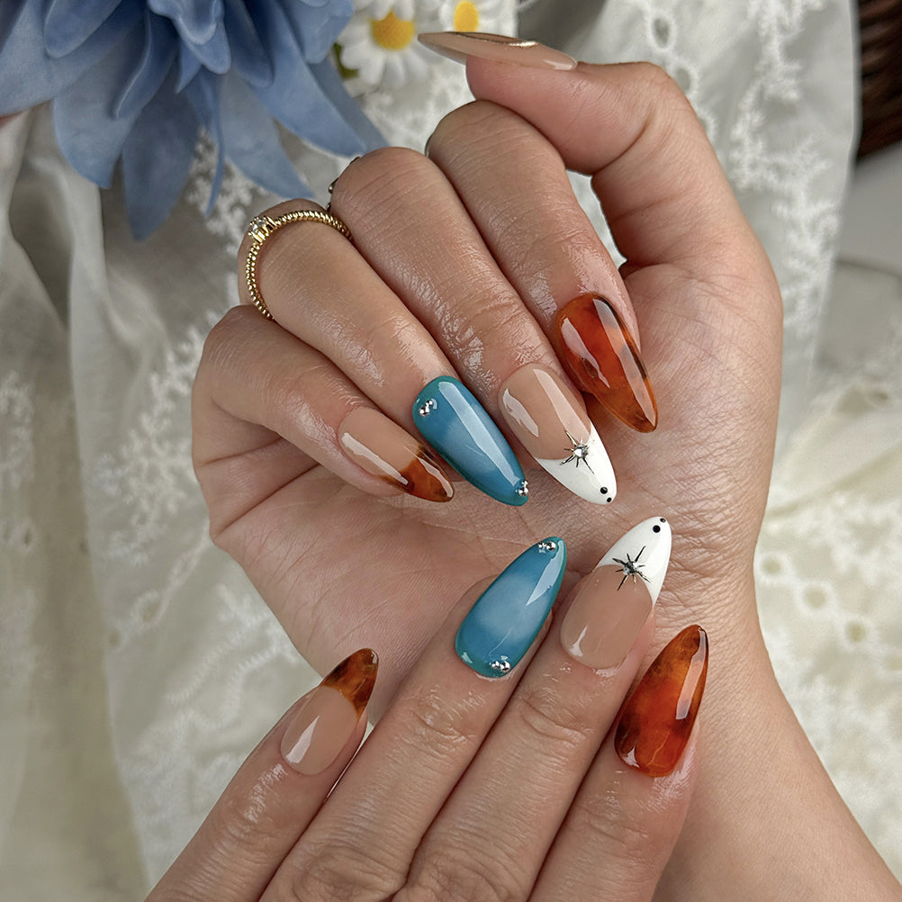 blue and orange nails medium almond press-on nails with nude base blue accents warm amber tips and simple nail art fall holiday style