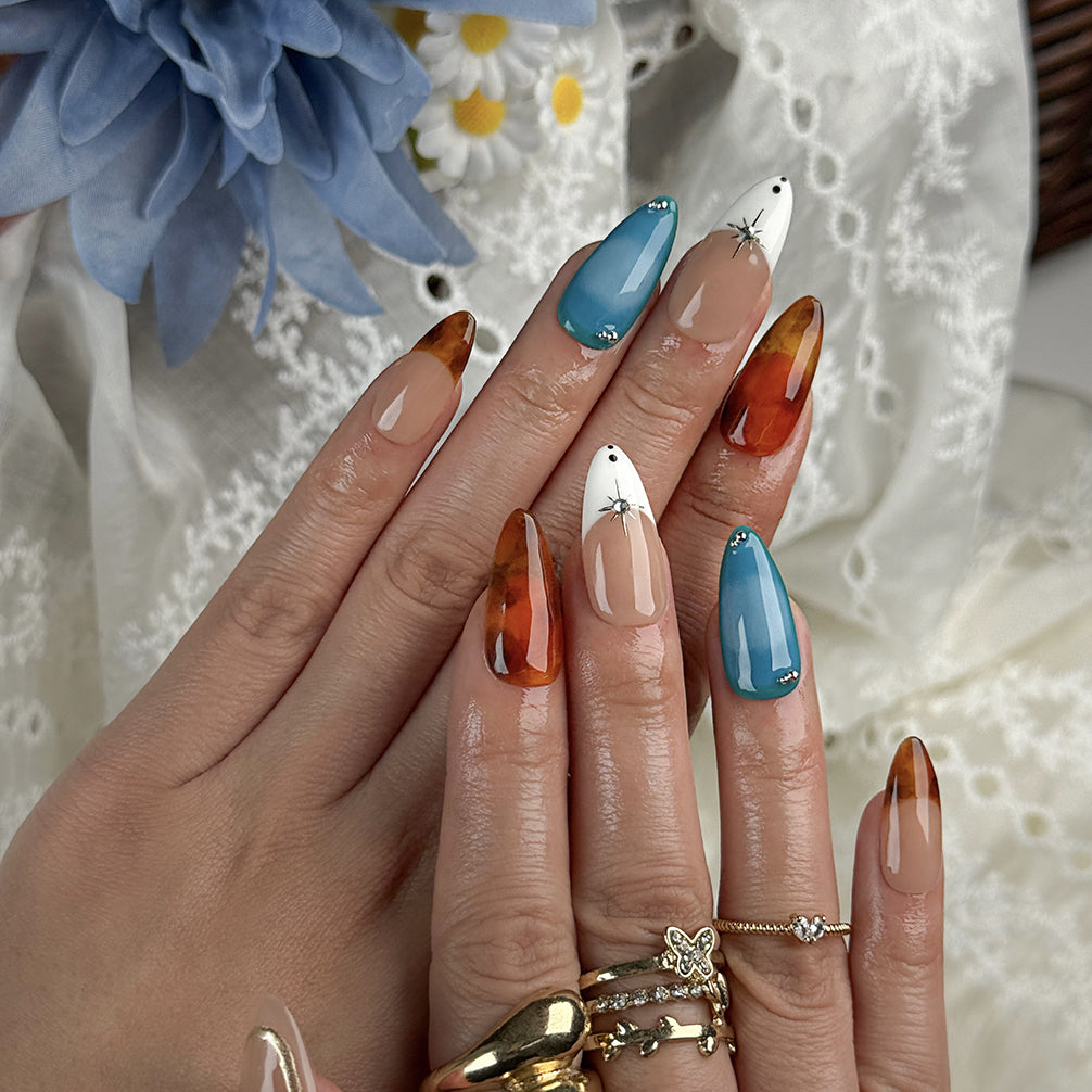 blue and orange nails medium almond press-on nails with nude base blue accents warm amber tips and simple nail art fall holiday style