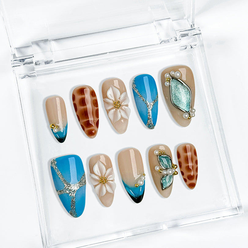 blue floral nails medium almond press-on nails with blue and brown accents flower details pearl-like accents luxury summer holiday style