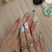 blue floral nails medium almond press-on nails with blue and brown accents flower details pearl-like accents luxury summer holiday style