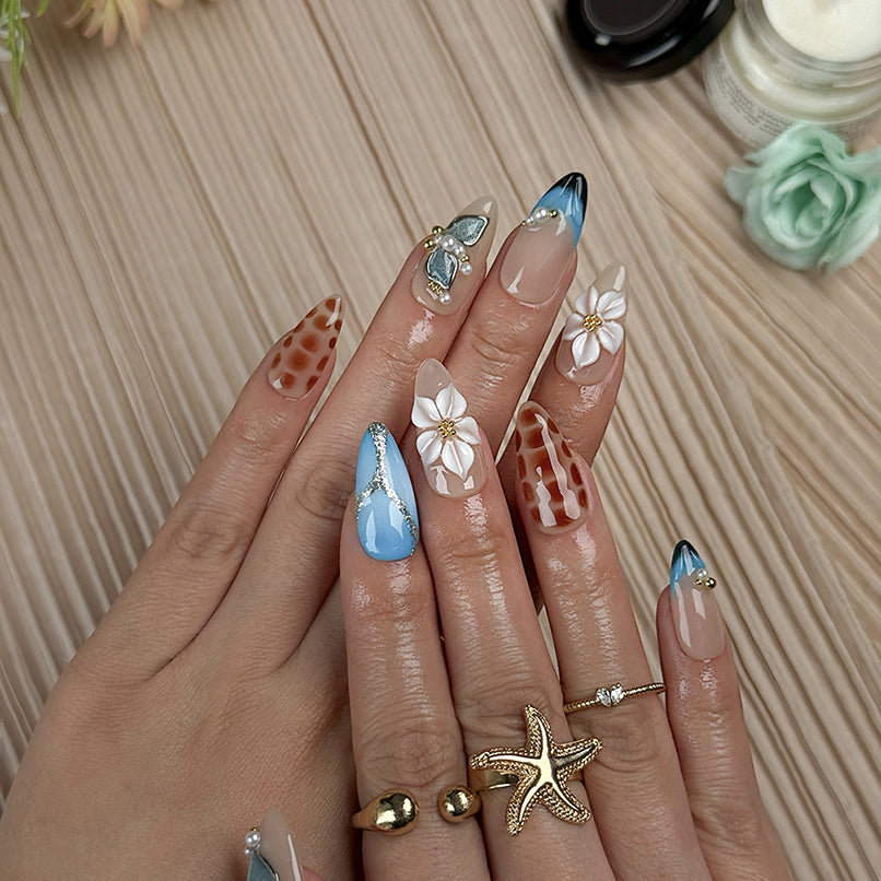 blue floral nails medium almond press-on nails with blue and brown accents flower details pearl-like accents luxury summer holiday style