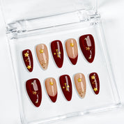 burgundy gold nail designs medium almond press-on nails with burgundy red nude accents french tips and gold star details for winter wedding style