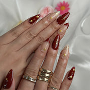 burgundy gold nail designs medium almond press-on nails with burgundy red nude accents french tips and gold star details for winter wedding style