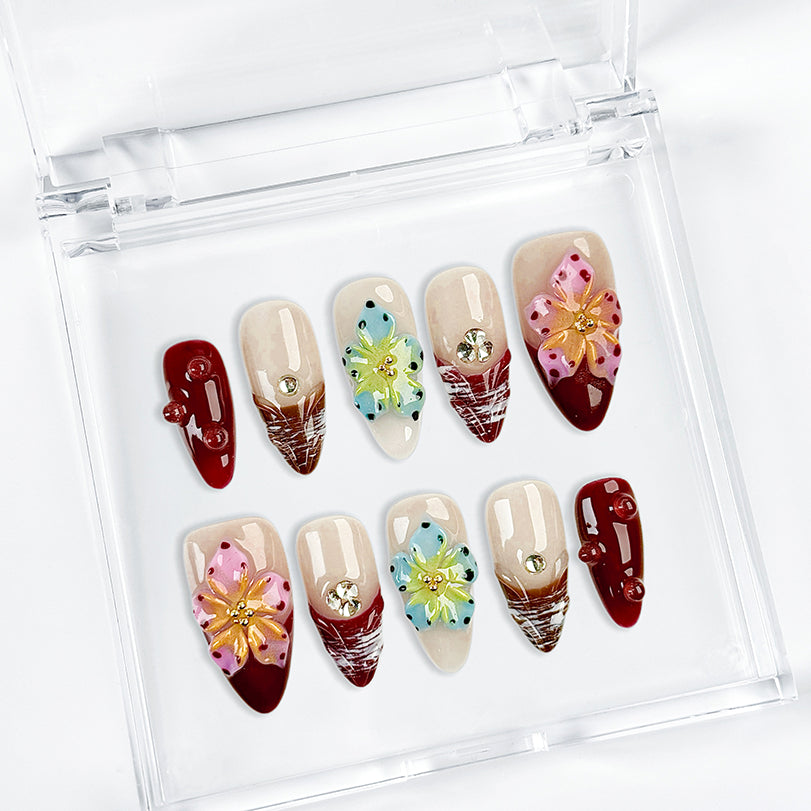 burgundy gold nails medium almond nude red press-on nails with flower accents and glossy finish