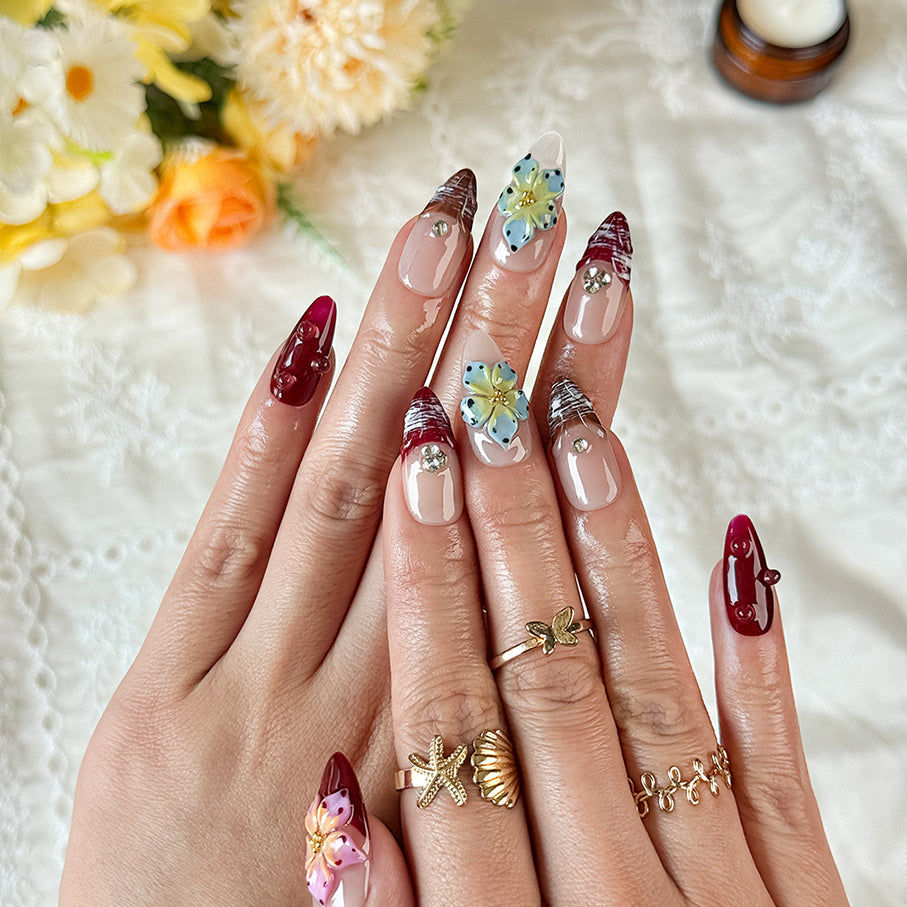 burgundy gold nails medium almond nude red press-on nails with flower accents and glossy finish
