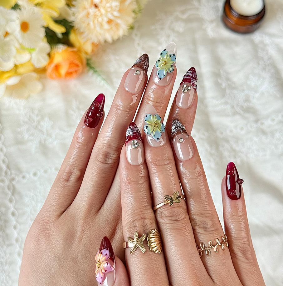 burgundy gold nails medium almond nude red press-on nails with flower accents and glossy finish