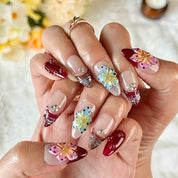 burgundy gold nails medium almond nude red press-on nails with flower accents and glossy finish