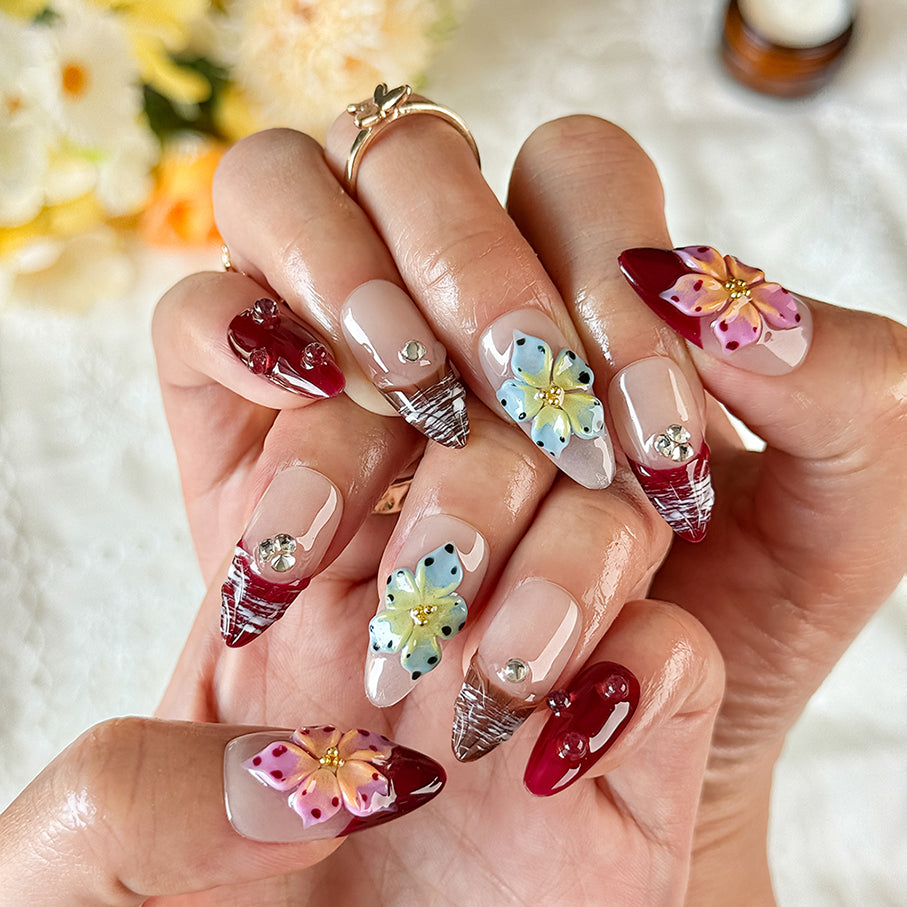burgundy gold nails medium almond nude red press-on nails with flower accents and glossy finish