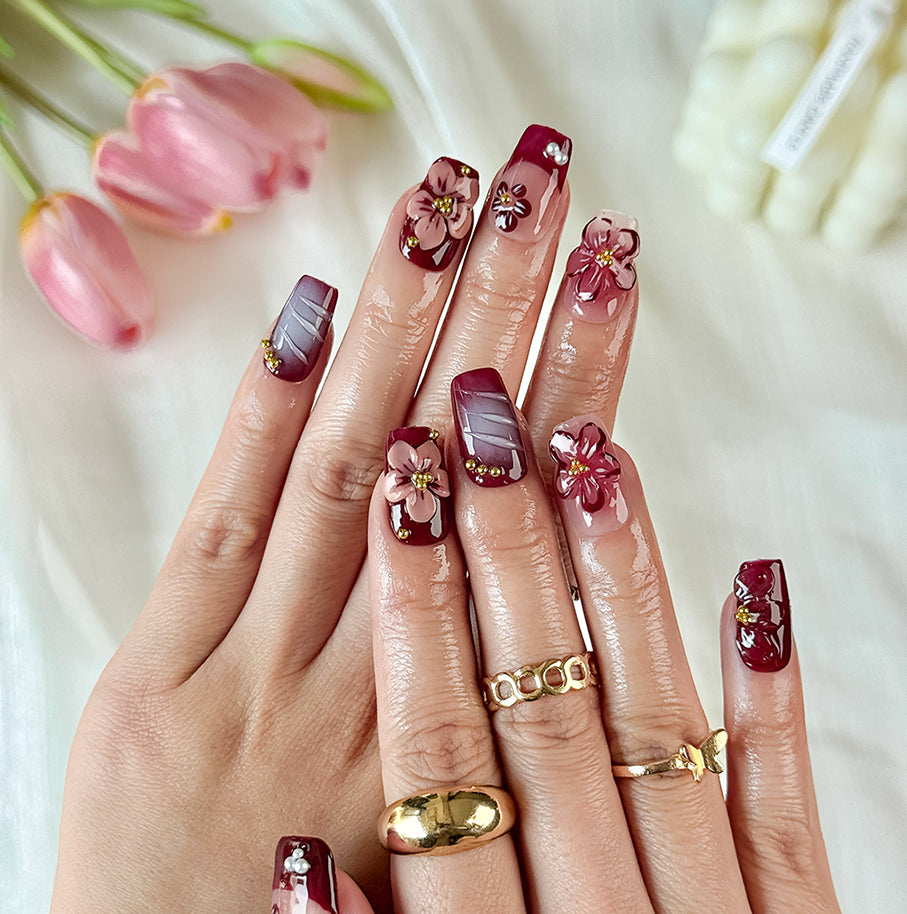 burgundy gold nails short square brown red press-on nails with flower accents and French tip detail