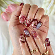 burgundy gold nails short square brown red press-on nails with flower accents and French tip detail