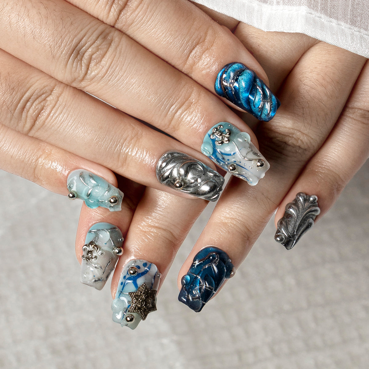 Arctic Blue Chrome COSH0009 press-on nails hand model scene view 2
