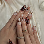dark red nails design medium almond press-on nails with burgundy and brown tones gold accents and flower detail fall holiday style