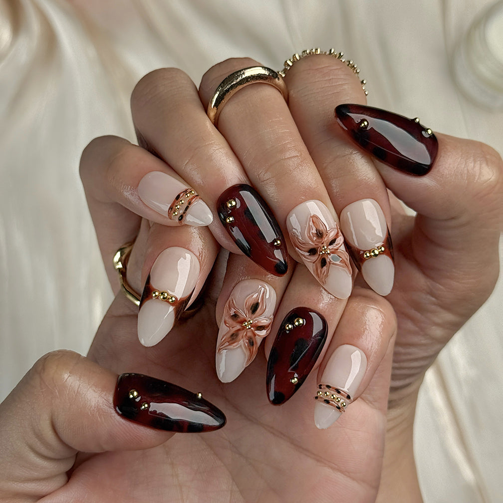 dark red nails design medium almond press-on nails with burgundy and brown tones gold accents and flower detail fall holiday style