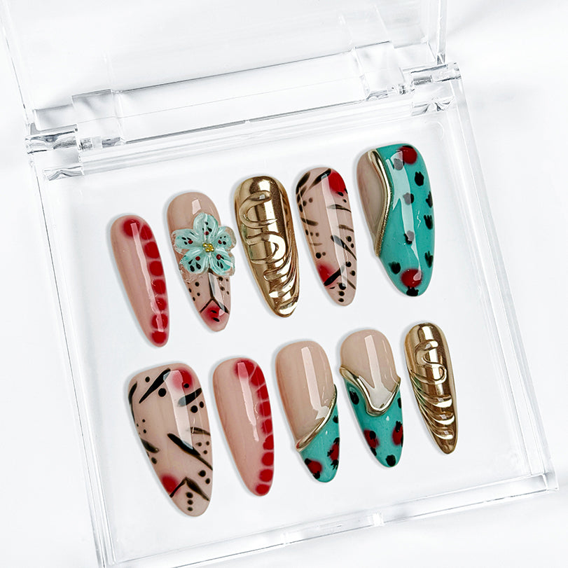 gold and nude nails long almond press-on nails with nude base green accents gold metallic luster and flower detail for summer holiday style