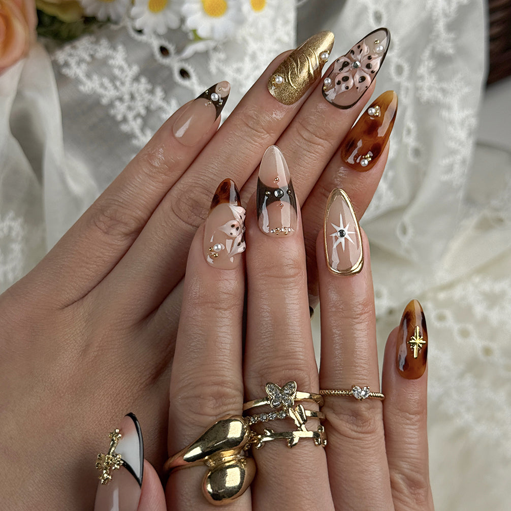 gold and nude nails medium almond press-on nails with nude base mocha brown accents gold shimmer and luxury details prom summer winter style