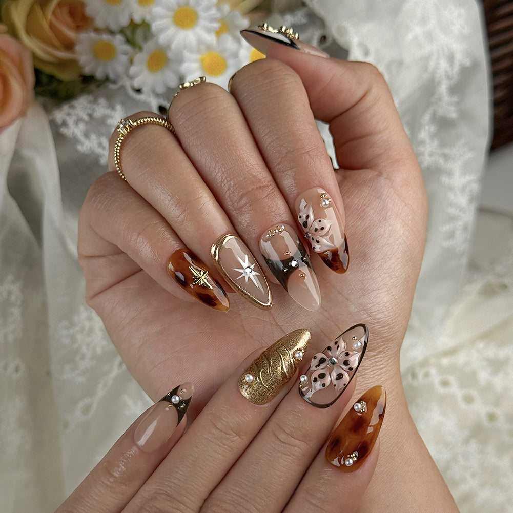 gold and nude nails medium almond press-on nails with nude base mocha brown accents gold shimmer and luxury details prom summer winter style