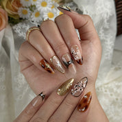 gold and nude nails medium almond press-on nails with nude base mocha brown accents gold shimmer and luxury details prom summer winter style