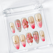 gold and nude nails medium almond pink press-on nails with flower accents and French tip detail