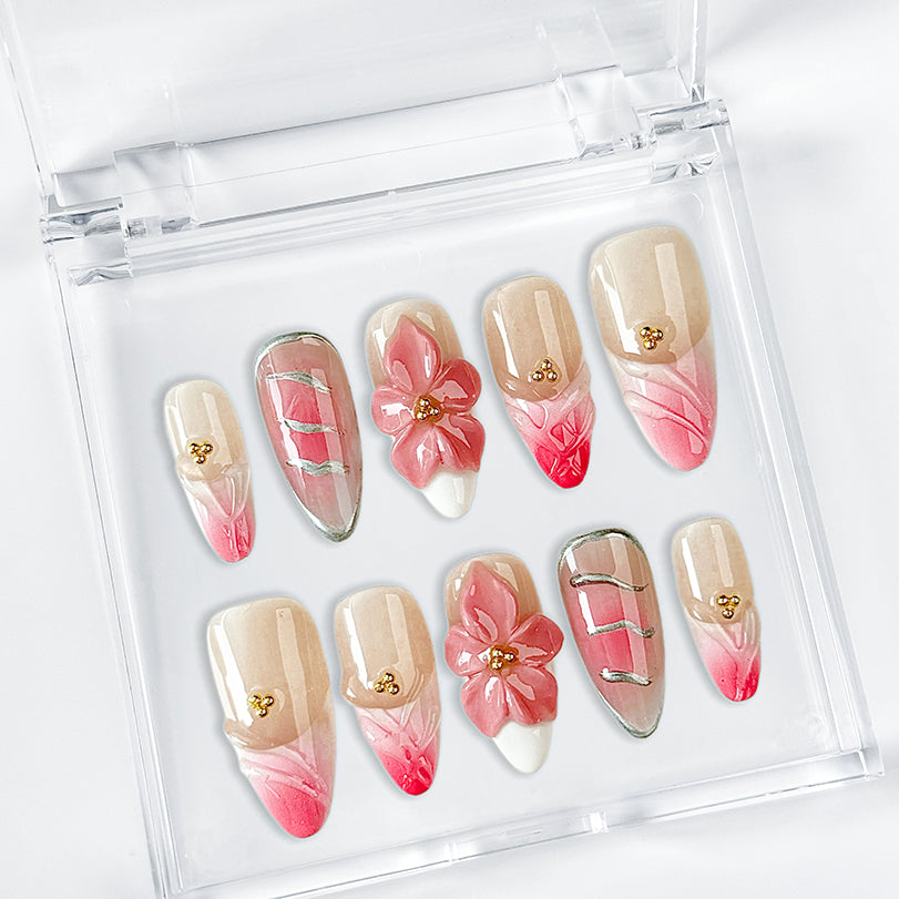 gold and nude nails medium almond pink press-on nails with flower accents and French tip detail