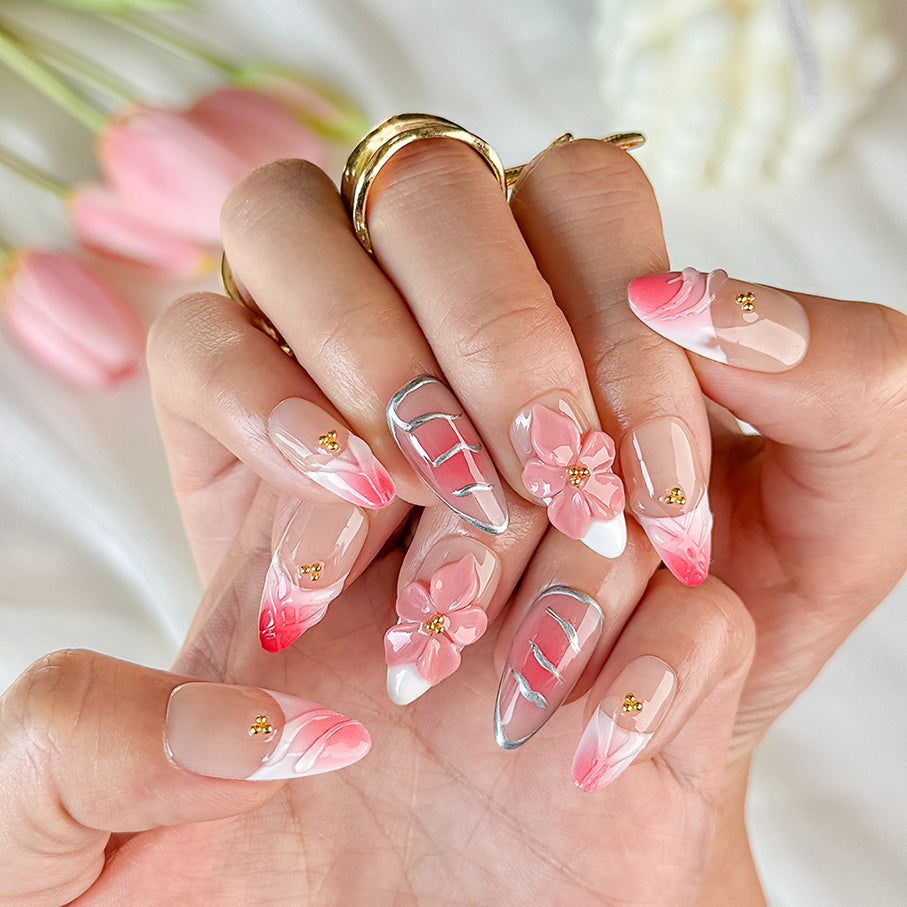 gold and nude nails medium almond pink press-on nails with flower accents and French tip detail
