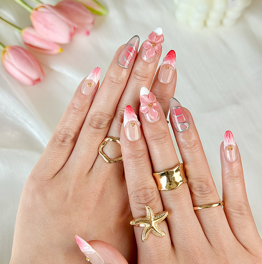 gold and nude nails medium almond pink press-on nails with flower accents and French tip detail
