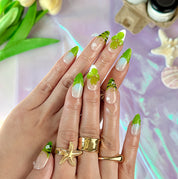 green flower nails medium almond nude press-on nails with floral accents and green French tip design