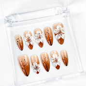 light brown nail medium almond press-on nails with white flower detail for holiday prom fall winter