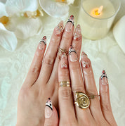 light brown nail medium almond nude brown press-on nails with flower accents and French tip detail