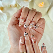 light brown nail medium almond nude brown press-on nails with flower accents and French tip detail