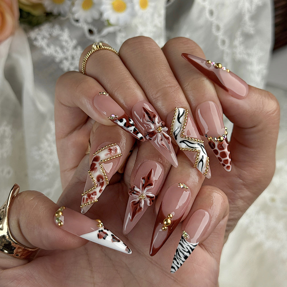 light pink almond nails long stiletto press-on nails with rosy nude base brown red accents french tips flower detail and luxury bling for prom fall winter style
