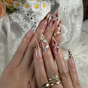 light pink almond nails long stiletto press-on nails with rosy nude base brown red accents french tips flower detail and luxury bling for prom fall winter style