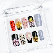 lilac nails with flowers medium square press-on nails with black and orange accents lilac tone nails and floral details spring beach party style