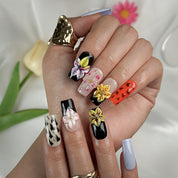 lilac nails with flowers medium square press-on nails with black and orange accents lilac tone nails and floral details spring beach party style