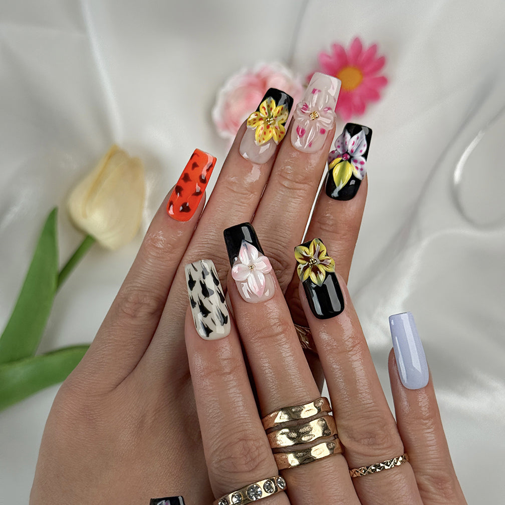 lilac nails with flowers medium square press-on nails with black and orange accents lilac tone nails and floral details spring beach party style