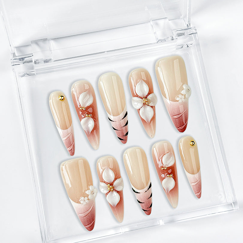 nail art white flowers long stiletto nude red press-on nails with French tip and floral detail